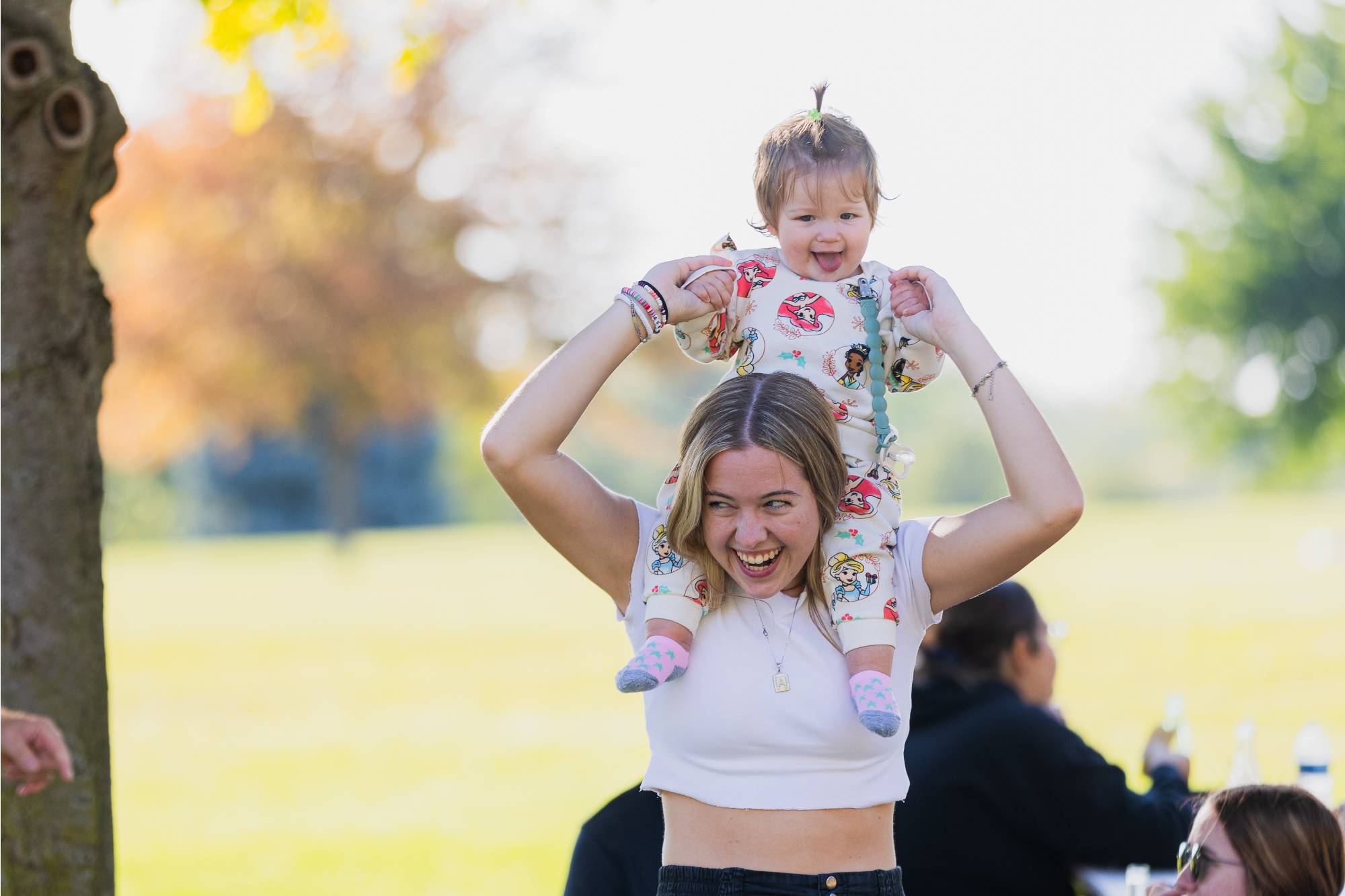 baby on woman's shoulders